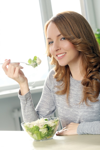 Foto gratuita hermosa mujer comiendo con linda sonrisa