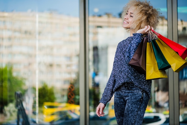 Foto gratuita hermosa mujer comprador con bolsas en la tienda