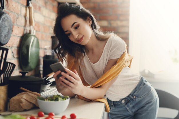 Hermosa mujer joven en la cocina