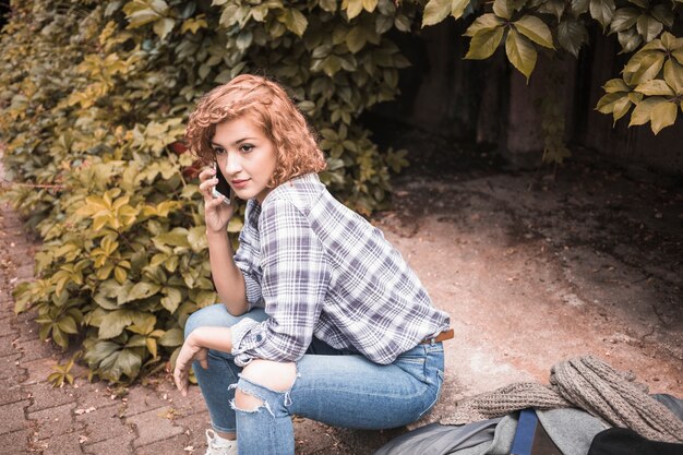 Hermosa mujer joven llamando por teléfono