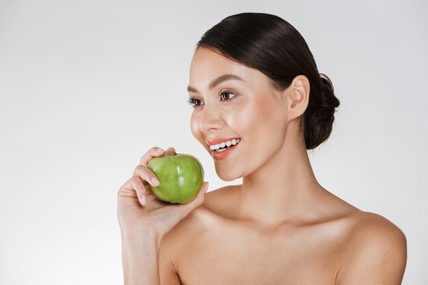 Hermosa mujer joven con manzana.