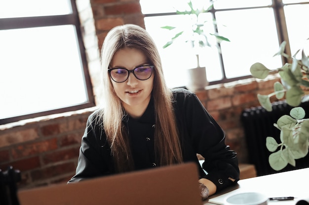 Hermosa mujer joven en la oficina en casa. trabajando desde casa. concepto de teletrabajo