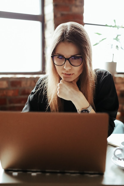 Hermosa mujer joven en la oficina en casa. Trabajando desde casa. Concepto de teletrabajo