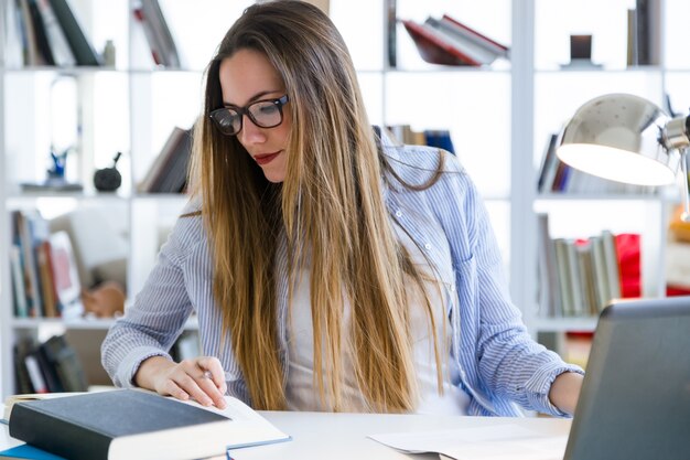 Hermosa mujer joven que trabaja en su oficina.