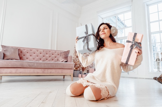 Hermosa mujer joven en vestido blanco. Concepto de navidad