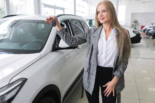 Hermosa mujer con las llaves del auto mirando a otro lado