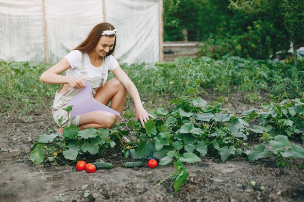 Hermosa mujer trabaja en un jardín