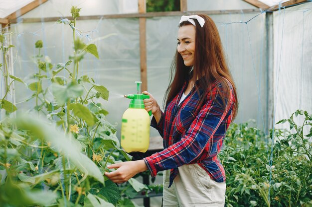 Hermosa mujer trabaja en un jardín