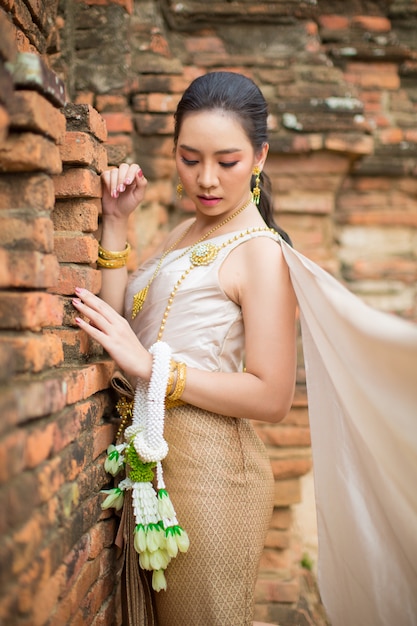 Hermosa mujer en traje tradicional tailandés antiguo, retrato en el antiguo templo de ayutthaya