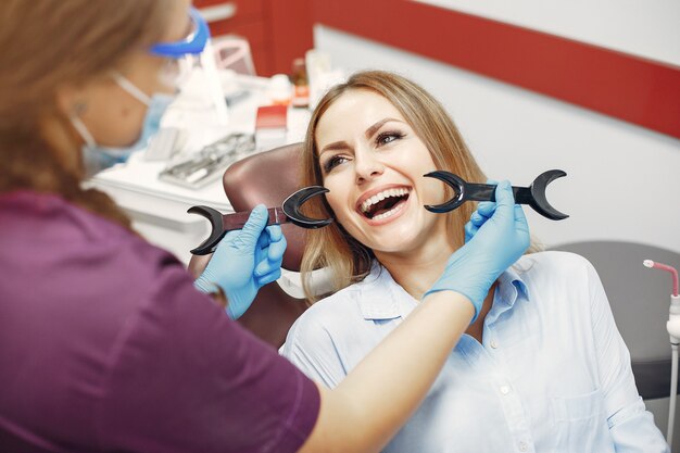 Hermosa niña sentada en el consultorio del dentista