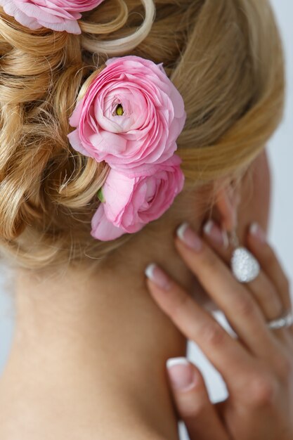 Hermosa novia con rosas en el pelo