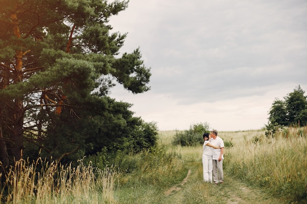 Hermosa pareja adulta pasa tiempo en un campo de verano