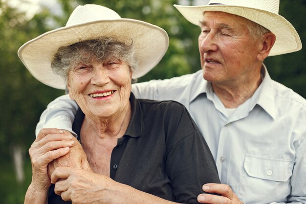 Hermosa pareja de ancianos pasar tiempo en un jardín de verano