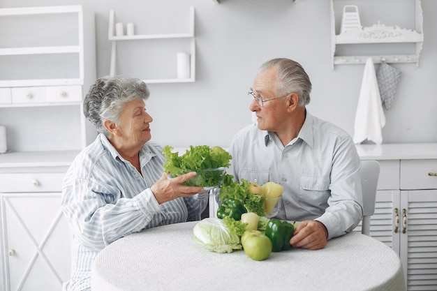 Hermosa pareja de ancianos prepara la comida en la cocina