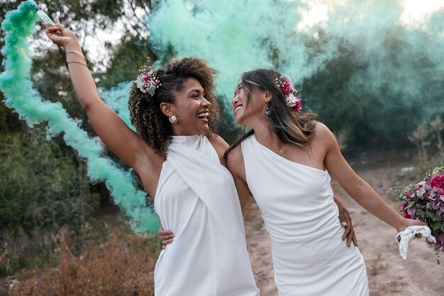 Una hermosa pareja de lesbianas celebrando su día de bodas al aire libre.