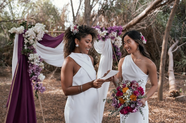 Foto gratuita una hermosa pareja de lesbianas celebrando su día de bodas al aire libre.