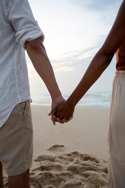 Hermosa pareja mostrando afecto en la playa cerca del océano