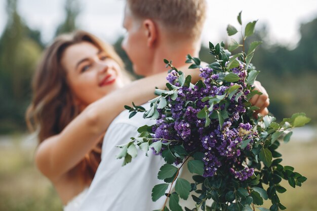 Hermosa pareja de novios en un campo de verano