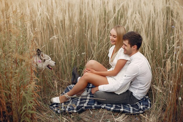 Hermosa pareja pasa tiempo en un campo de otoño