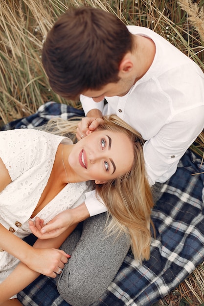 Hermosa pareja pasa tiempo en un campo de otoño