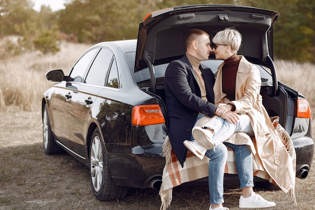 Hermosa pareja pasa tiempo en un campo de otoño