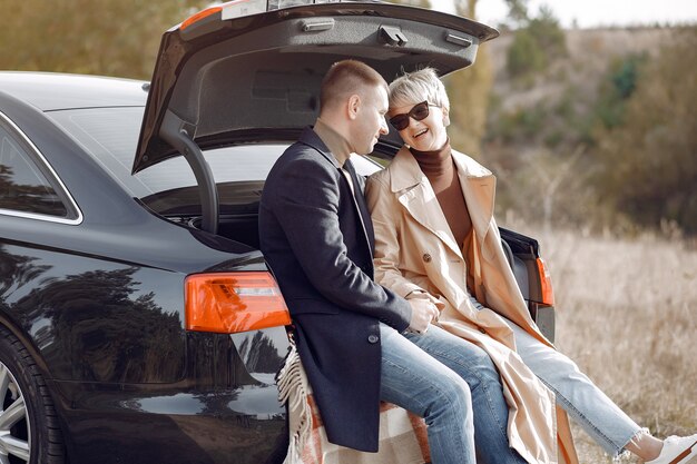 Hermosa pareja pasa tiempo en un campo de otoño