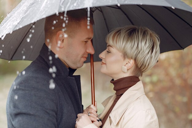 Hermosa pareja pasa tiempo en un campo de otoño