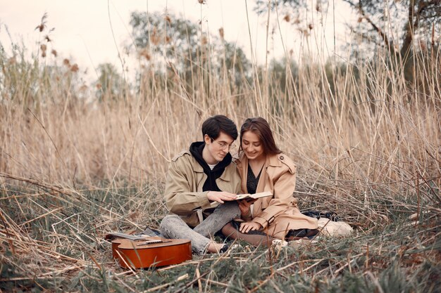 Hermosa pareja pasa tiempo en un campo de otoño