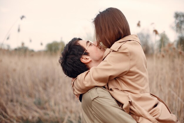 Hermosa pareja pasa tiempo en un campo de otoño