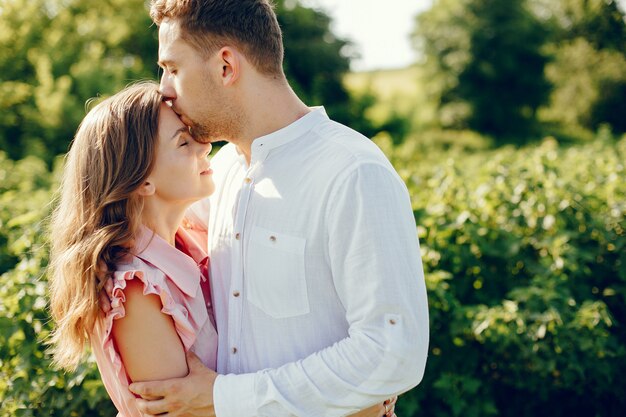 Hermosa pareja pasa tiempo en un campo de verano