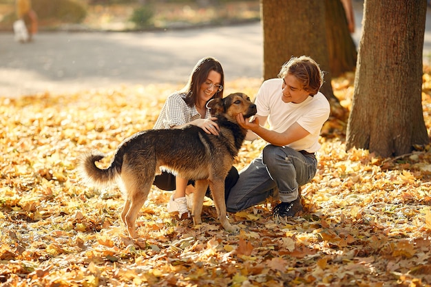 Hermosa pareja pasa tiempo en un parque de otoño