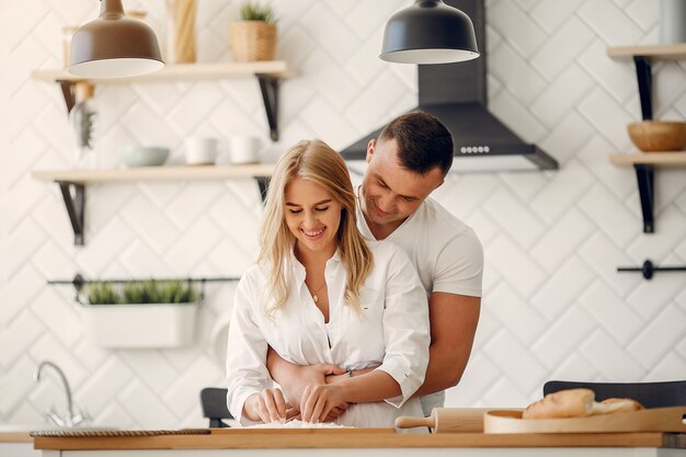 Hermosa pareja prepara comida en una cocina