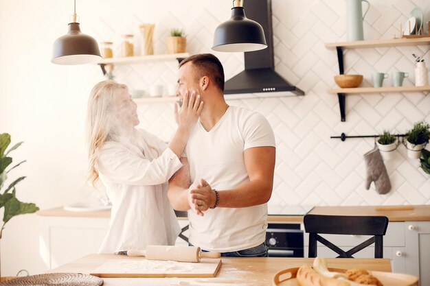 Hermosa pareja prepara comida en una cocina