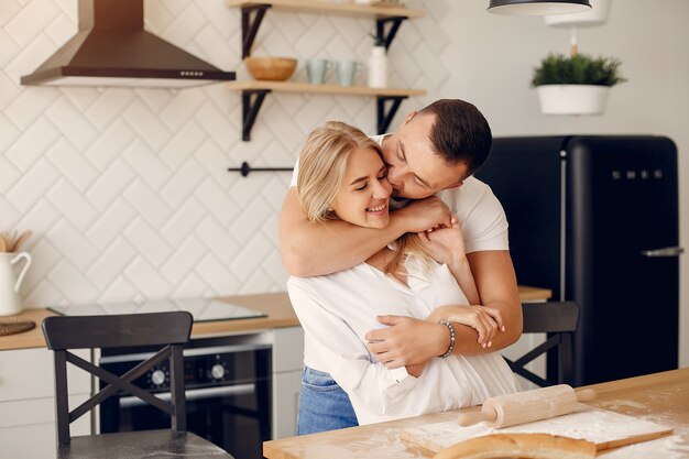 Hermosa pareja prepara comida en una cocina