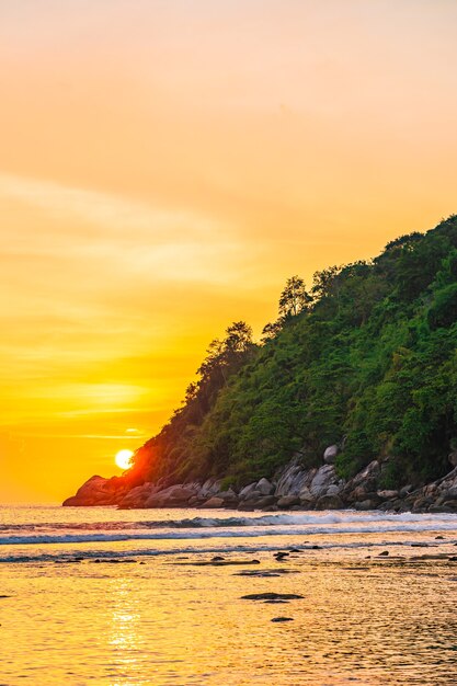 Hermosa puesta de sol sobre la montaña alrededor de la playa, mar, océano y roca