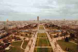 Foto gratuita hermosa toma aérea de los jardines de la tour eiffel bajo las nubes de tormenta