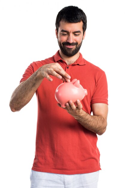 Hermoso hombre con un piggybank