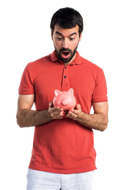 Hermoso hombre con un piggybank