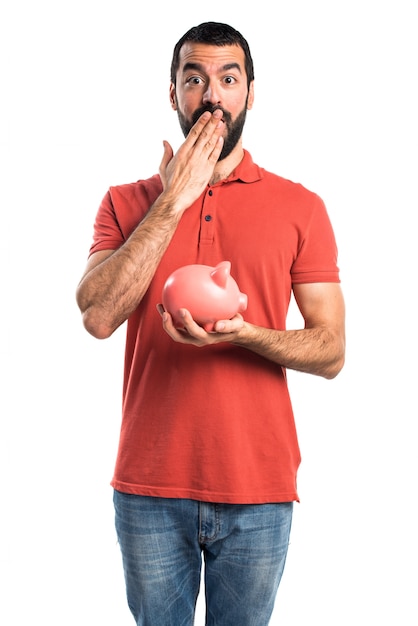 Foto gratuita hermoso hombre con un piggybank