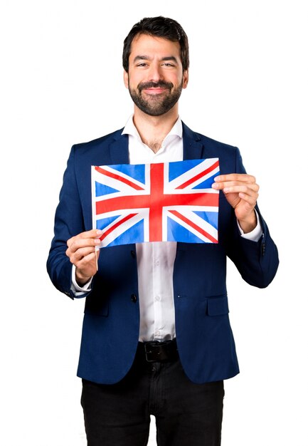 Hermoso hombre sosteniendo una bandera del Reino Unido