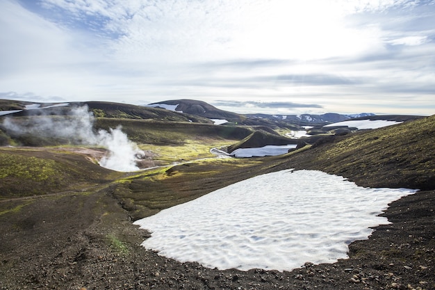 Foto gratuita hermoso paisaje de charcos de agua hirviendo y nieve en las montañas