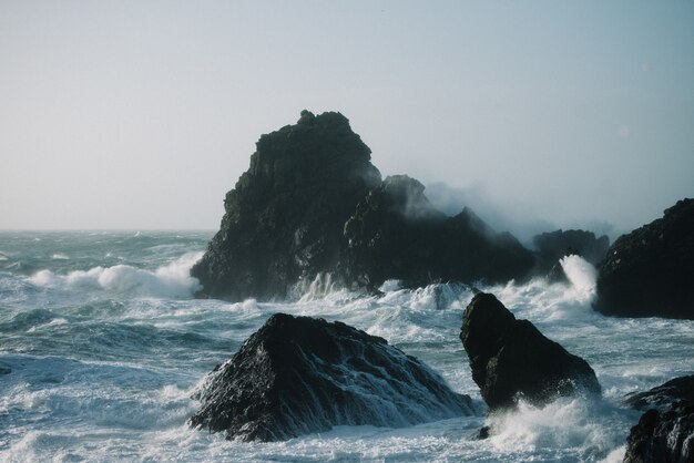 Hermoso paisaje de olas del mar rompiendo sobre formaciones rocosas