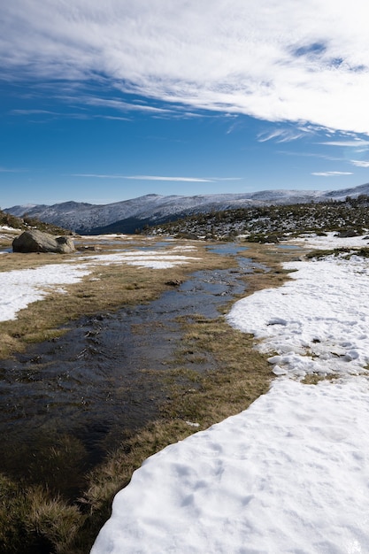 Hermoso paisaje de un paisaje cubierto de nieve con acantilados rocosos bajo un cielo nublado