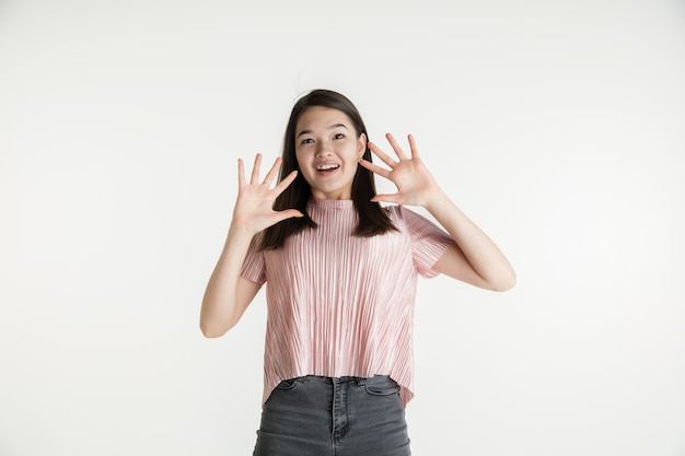 Hermoso retrato femenino de medio cuerpo aislado sobre fondo blanco de estudio. Mujer joven emocional en ropa casual. Las emociones humanas, el concepto de expresión facial. Asombrado, asombrado, llamando a ventas.