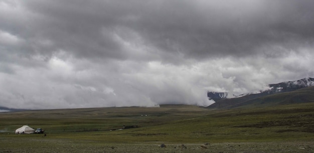 Foto gratuita hermoso tiro ancho de tierras bajas brumosas bajo un cielo gris sombrío