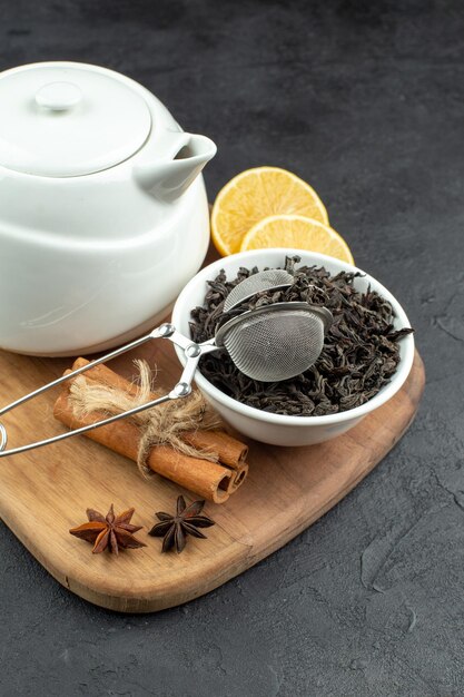 Hervidor de agua de vista frontal con té con canela y té negro sobre un fondo oscuro mesa de color de comida café de la mañana comida de huevo desayuno