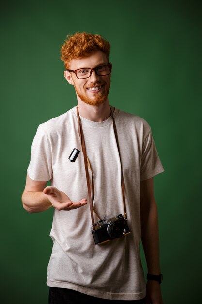 Hipster de cabeza lectora elegante guapo en camiseta blanca con cámara de fotos retro