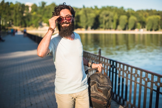 Hipster de vacaciones al lado de lago
