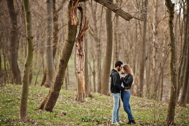 Historia de amor de una pareja multirracial genial en el bosque de primavera