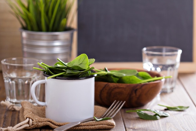 Hojas de espinacas verdes en una taza